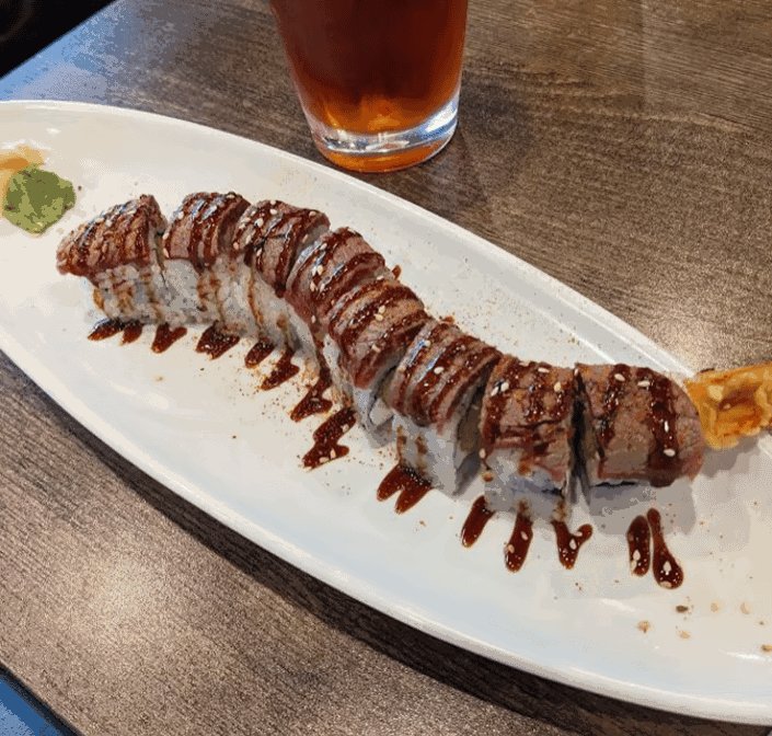 Colorful restaurant dishes with chopsticks nearby.
